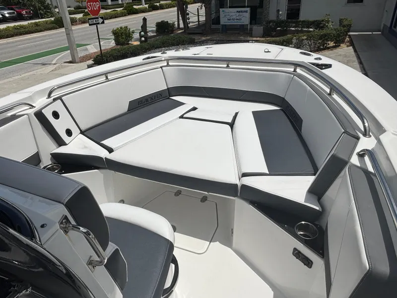 Slide: The Image of 2019 Blackfin 242 CC boat interior with cushioned seating and cup holders. - 7