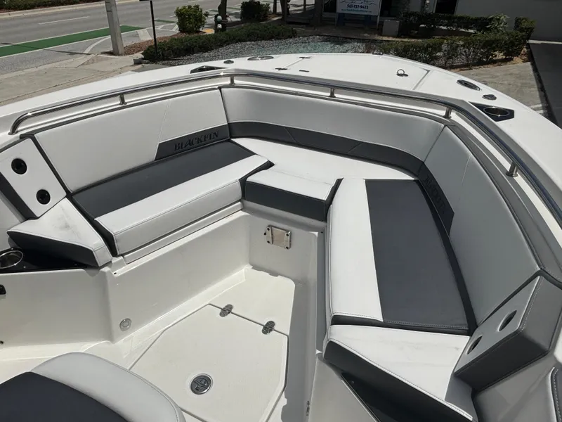 Slide: The Image of 2019 Blackfin 242 CC boat interior with cushioned seating and sleek design. - 8