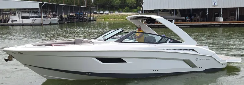 The Image of 2021 Cruisers Yachts 338 on water, sleek design. - 1