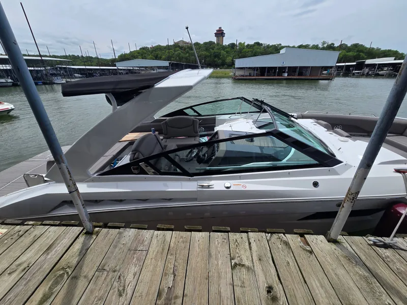 Slide: The Image of 2021 Cruisers Yachts 338 docked, with water and buildings in the background. - 10