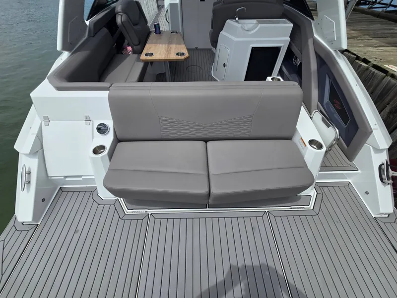 Slide: The Image of Interior of a 2021 Cruisers Yachts 338 with gray seating. - 15