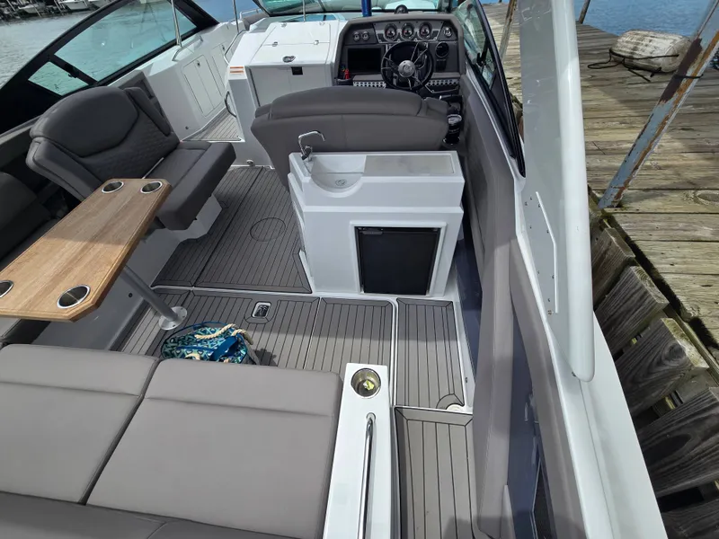 Slide: The Image of Interior of a 2021 Cruisers Yachts 338 with seating and helm station. - 16