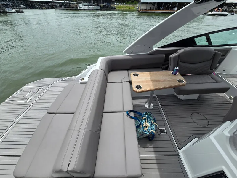 Slide: The Image of Interior of a 2021 Cruisers Yachts 338 with seating area and table. - 19