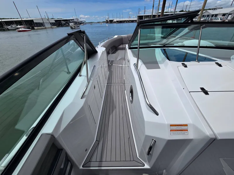 Slide: The Image of 2021 Cruisers Yachts 338 on calm waters in the harbor. - 23