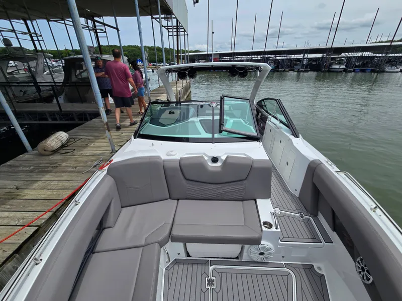 Slide: The Image of 2021 Cruisers Yachts 338 at dock with people in background. - 25
