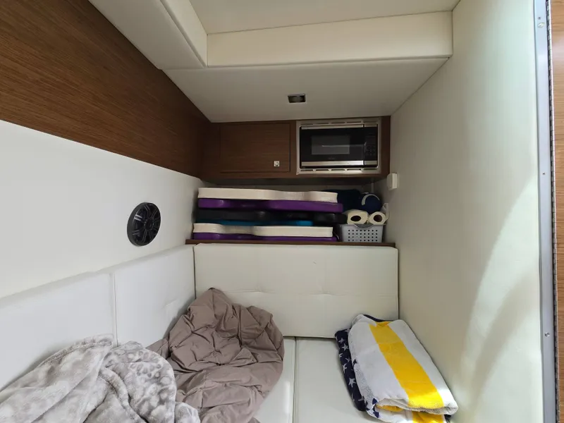 Slide: The Image of Interior of 2021 Cruisers Yachts 338 with microwave and bedding. - 30