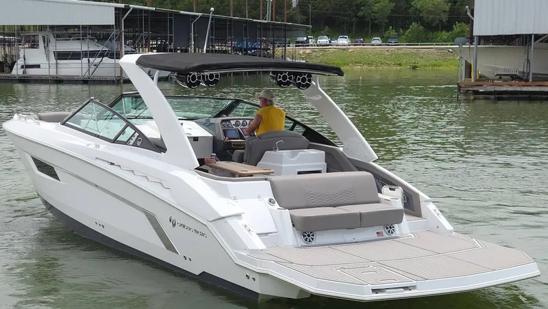 Slide: The Image of 2021 Cruisers Yachts 338 on calm water with driver. - 4