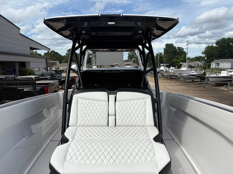 Slide: The Image of 2015 Nor-Tech 340 Sport boat with luxurious white seating area. - 10