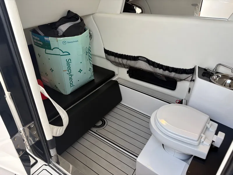 Slide: The Image of Interior of a 2015 Nor-Tech 340 Sport with toilet and storage area. - 4