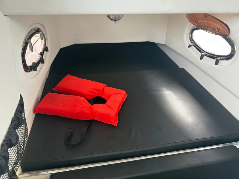 Slide: The Image of Interior of a 2015 Nor-Tech 340 Sport boat with red life jacket. - 5