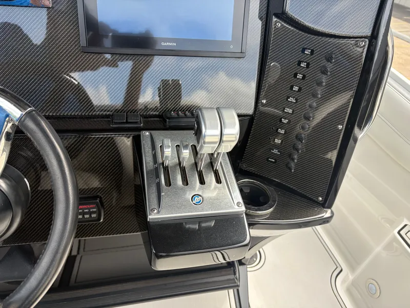 Slide: The Image of Dashboard of a 2015 Nor-Tech 340 Sport boat with controls. - 7