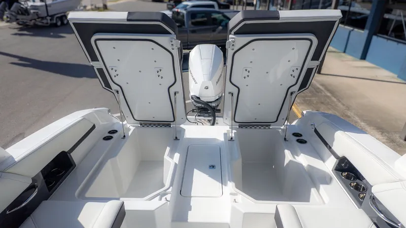 Slide: The Image of Cobalt R6 2026 boat with open storage compartments and engine view. - 15