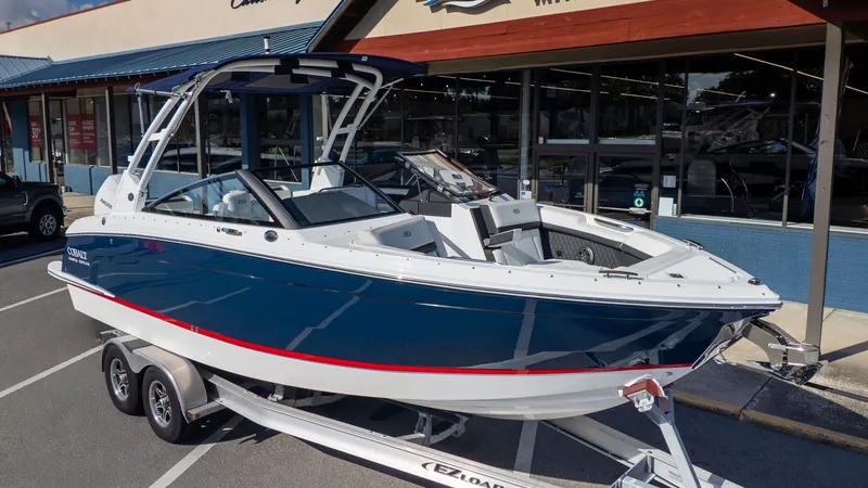 Slide: The Image of 2026 Cobalt R6 boat on trailer outside store. - 2