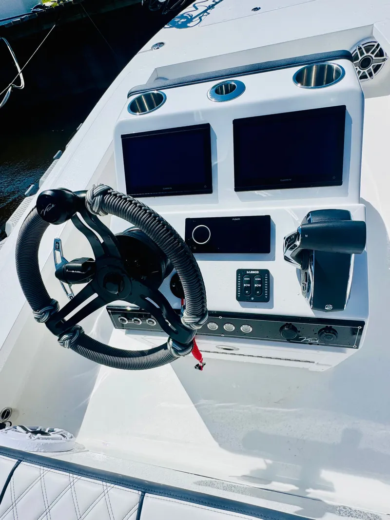 Slide: The Image of Vtech 18' Flats 2027 boat console with steering wheel and screens. - 12