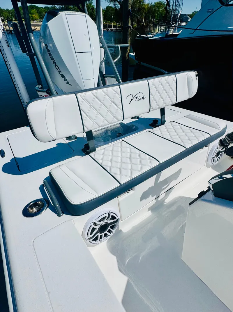 Slide: The Image of Vtech 18' Flats boat with white cushioned seating, model year 2027. - 13