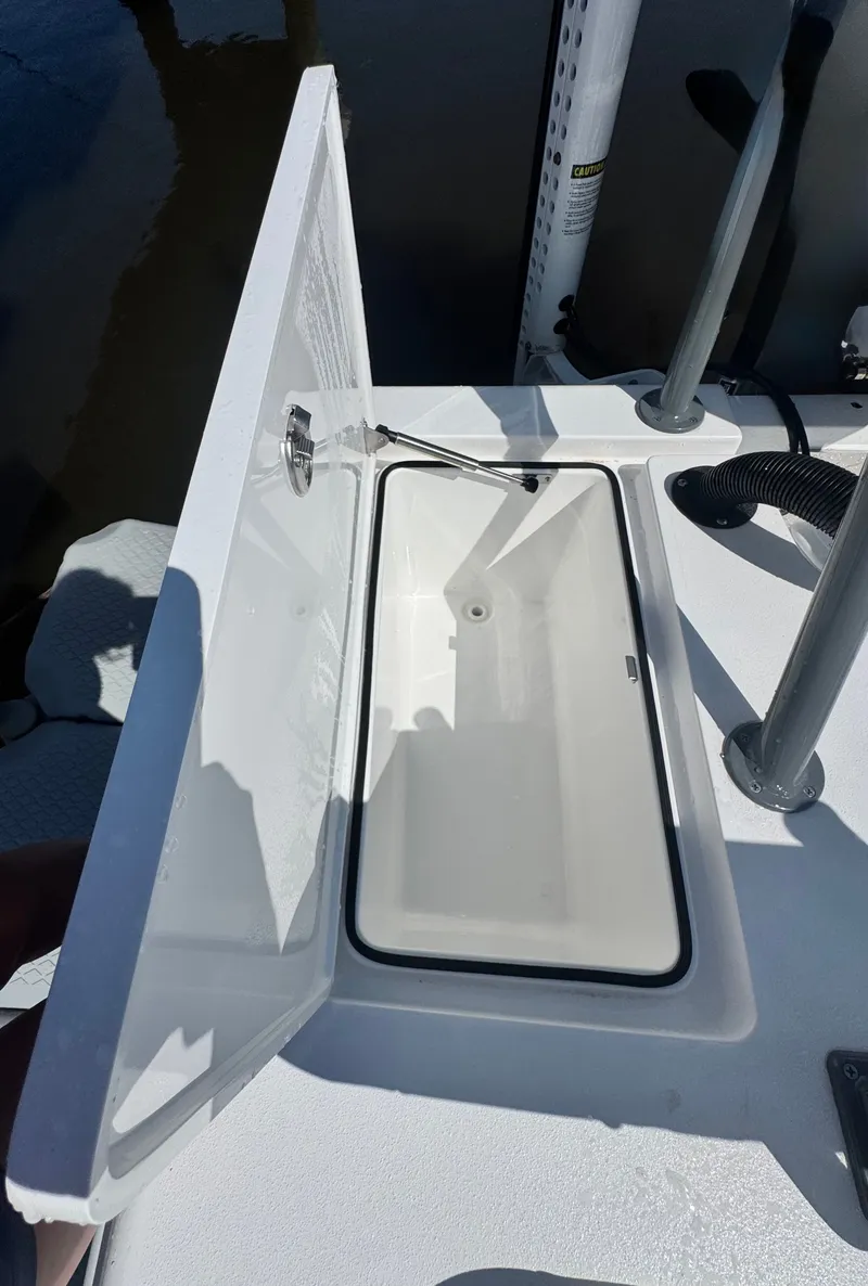 Slide: The Image of Open storage compartment on a 2027 Vtech 18' Flats boat. - 18