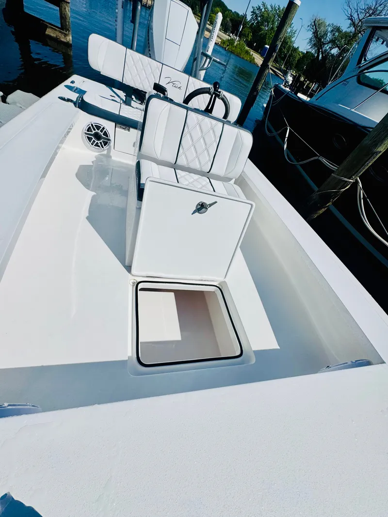 Slide: The Image of Vtech 18' Flats boat, 2027 model, with open storage at dock. - 28