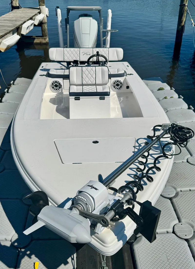 Slide: The Image of Vtech 18' Flats boat from 2027 docked on water. - 35
