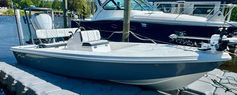 Slide: The Image of Vtech 18' Flats boat, 2027 model, docked at marina. - 36