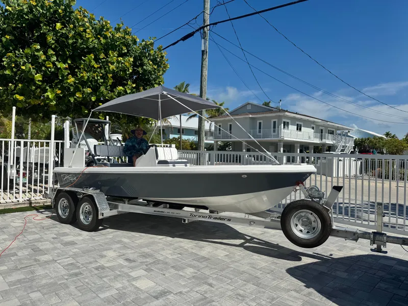 Slide: The Image of Vtech 18' Flats boat on trailer in front of house, 2027 model. - 6