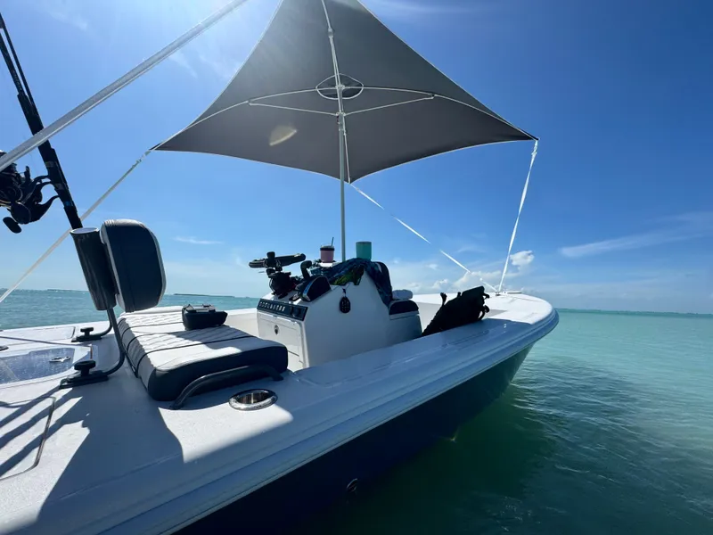 Slide: The Image of Vtech 18' Flats boat 2027 on calm water with sunshade. - 9