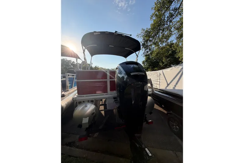 Slide: The Image of 2026 Sun Tracker Party Barge 18 DLX pontoon boat with canopy and outboard motor. - 2