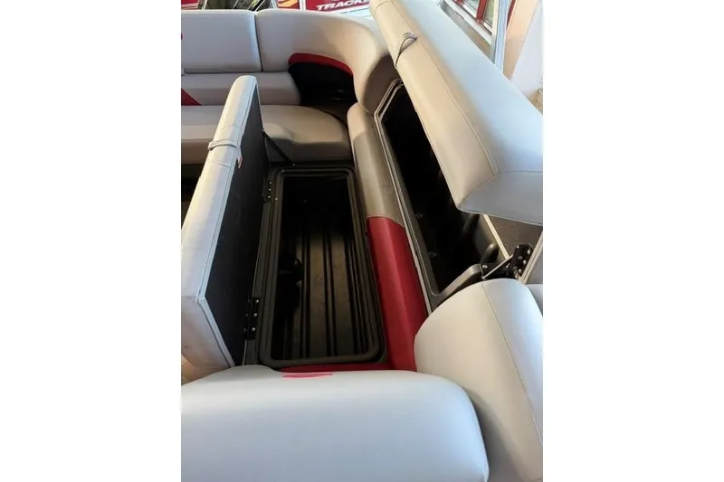 Slide: The Image of 2026 Sun Tracker Party Barge 20 DLX interior seating with open storage compartments. - 11