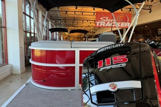 Slide: The Image of 2026 Sun Tracker Party Barge 20 DLX with Mercury 115 Pro engine in showroom. - 3