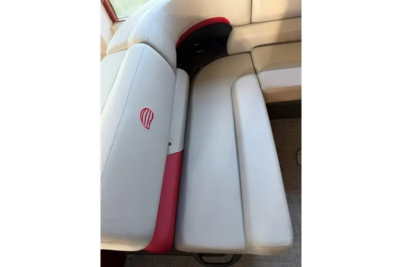 Slide: The Image of 2026 Sun Tracker Party Barge 20 DLX interior seating with white and red upholstery. - 10