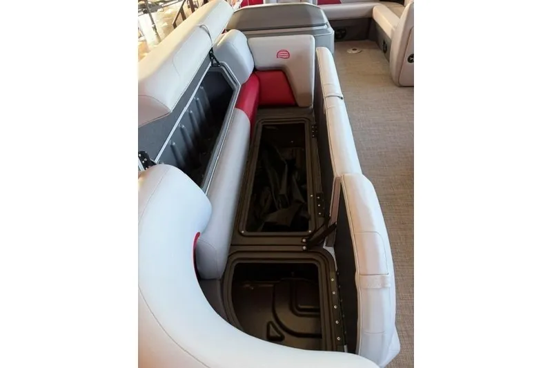 Slide: The Image of 2026 Sun Tracker Party Barge 20 DLX interior seating with open storage compartments. - 6