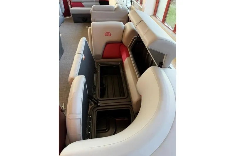 Slide: The Image of 2026 Sun Tracker Party Barge 20 DLX interior with open storage compartments. - 8