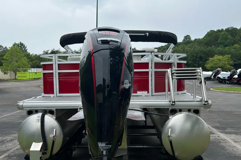 Slide: The Image of 2026 Sun Tracker Fishin' Barge 22 DLX pontoon boat with powerful outboard motor. - 2