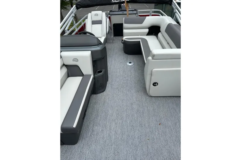Slide: The Image of 2026 Sun Tracker Fishin' Barge 22 DLX interior with gray and white seating. - 4
