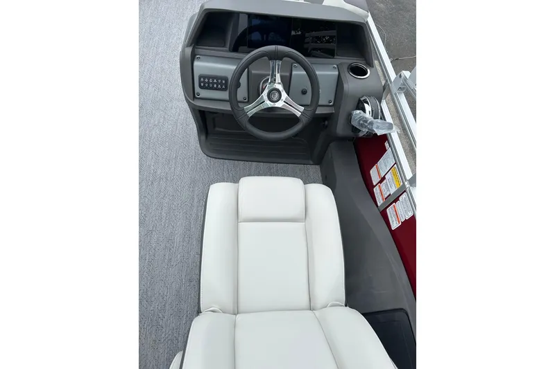Slide: The Image of 2026 Sun Tracker Fishin' Barge 22 DLX helm with steering wheel and comfortable seating. - 3