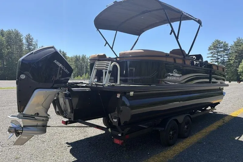 Slide: The Image of 2026 Regency 230 DL pontoon boat with Mercury outboard motor on trailer. - 5