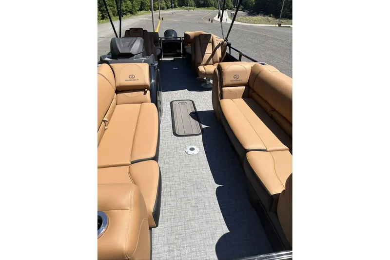 Slide: The Image of Luxurious 2026 Regency 230 DL pontoon boat with tan leather seating and spacious interior. - 8