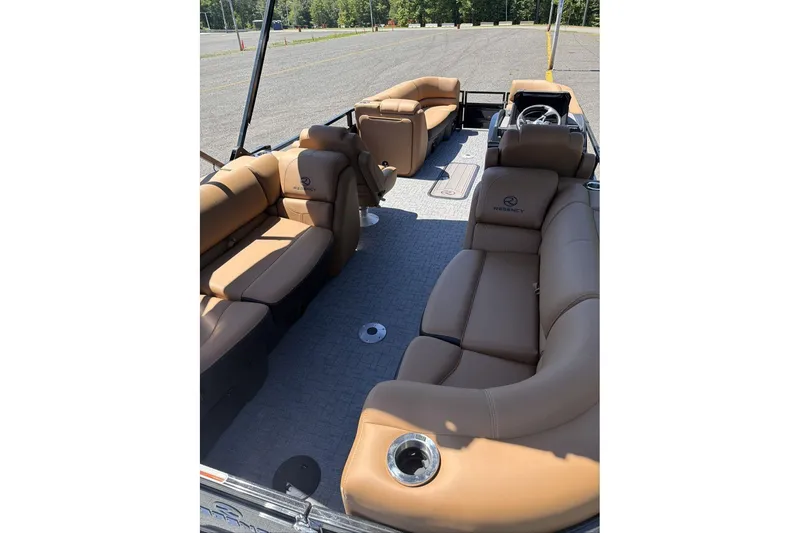 Slide: The Image of Luxurious 2026 Regency 230 DL pontoon boat with spacious tan seating and modern design. - 9
