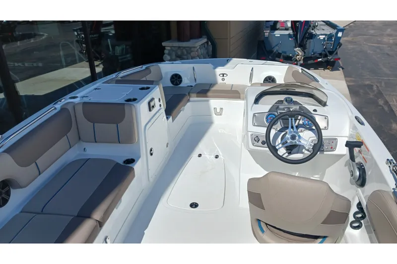 Slide: The Image of 2026 Tahoe 2150 boat interior with steering wheel, seating, and control panel. - 13