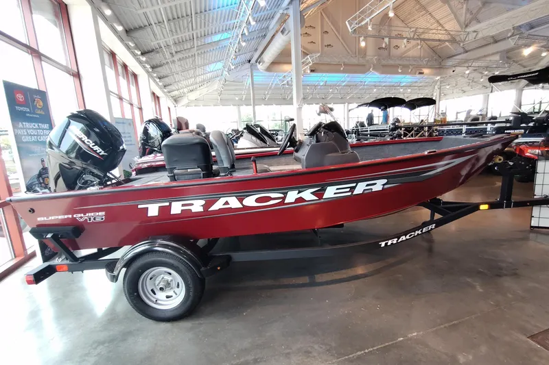 The Image of 2026 Tracker Super Guide V-16 SC boat displayed in a showroom. - 0