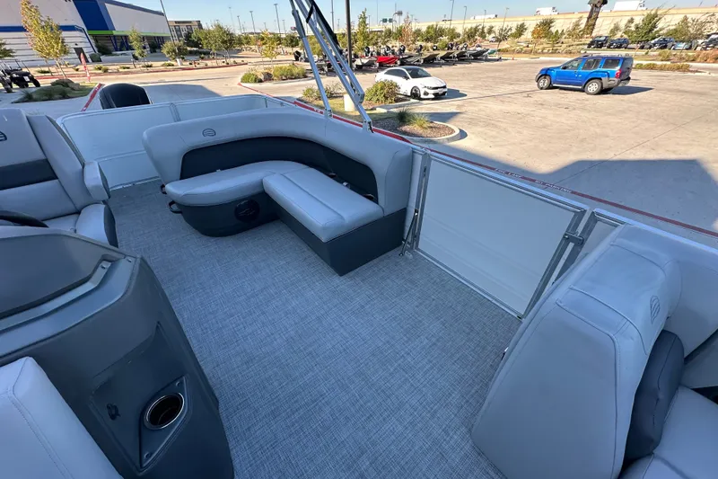 Slide: The Image of 2026 Sun Tracker Party Barge 18 DLX interior with gray seating and spacious layout. - 28