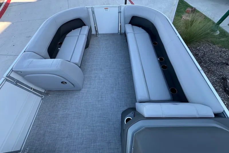 Slide: The Image of 2026 Sun Tracker Party Barge 18 DLX interior with spacious seating and cup holders. - 36