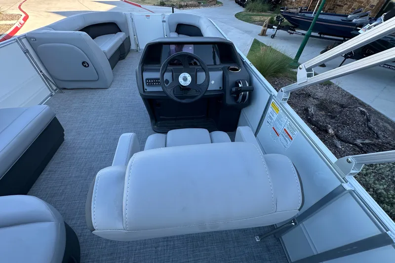 Slide: The Image of 2026 Sun Tracker Party Barge 18 DLX interior with steering console and seating. - 32