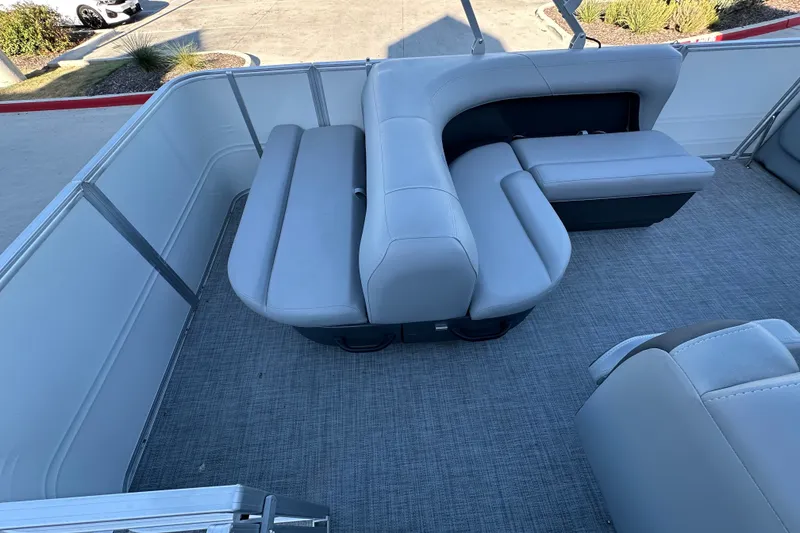Slide: The Image of 2026 Sun Tracker Party Barge 18 DLX interior with gray seating and carpeted flooring. - 30
