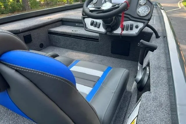 The Image of 2026 Ranger RT178 boat interior with steering wheel, gauges, and blue-accented seating. - 0