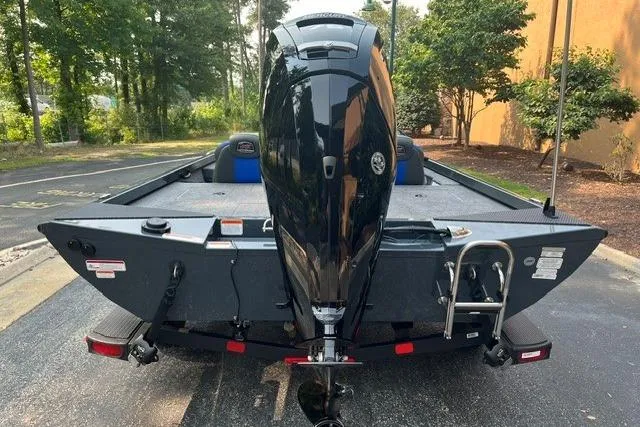 Slide: The Image of 2026 Ranger RT178 boat with outboard motor, parked outdoors on a sunny day. - 4