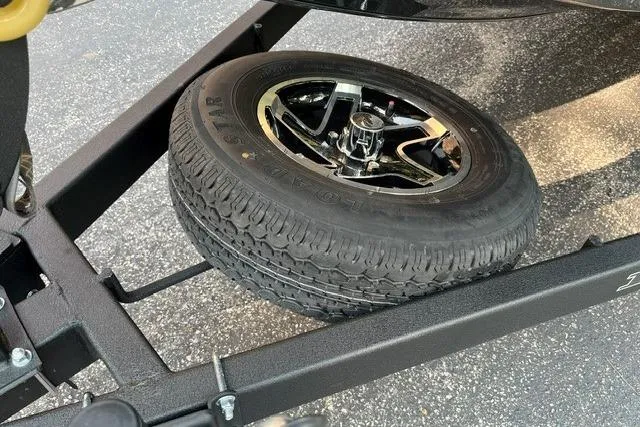 Slide: The Image of 2026 Ranger RT178 trailer with mounted spare tire on black frame. - 11