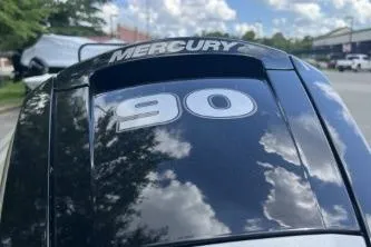 Slide: The Image of Mercury 90 engine on 2026 Tracker Grizzly 1860 CC boat under a cloudy sky. - 4