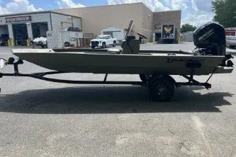The Image of 2026 Tracker Grizzly 1860 CC boat on trailer in outdoor setting. - 0