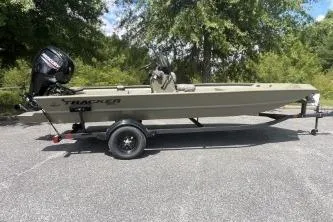 Slide: The Image of 2026 Tracker Grizzly 1860 CC boat on trailer, parked outdoors. - 7