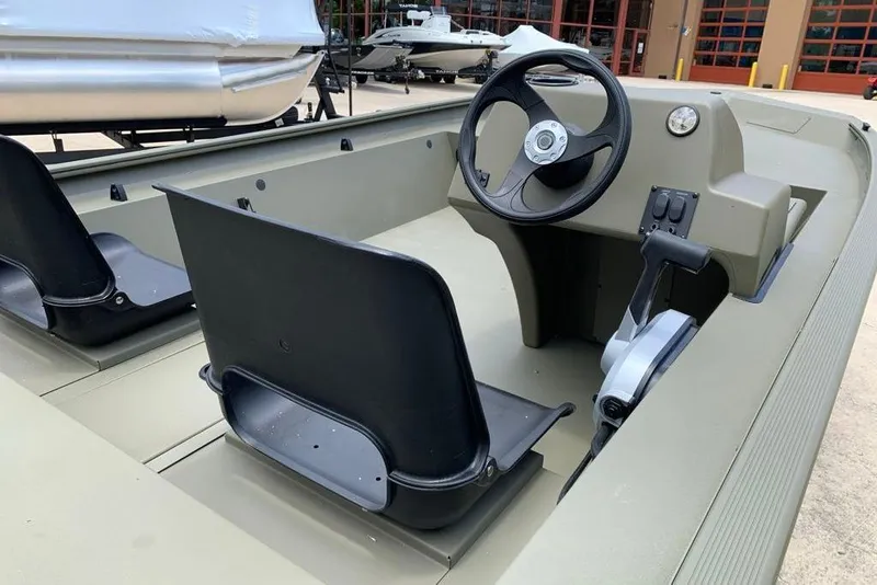 Slide: The Image of 2026 Tracker Grizzly 1754 SC boat interior with steering wheel and seating. - 6